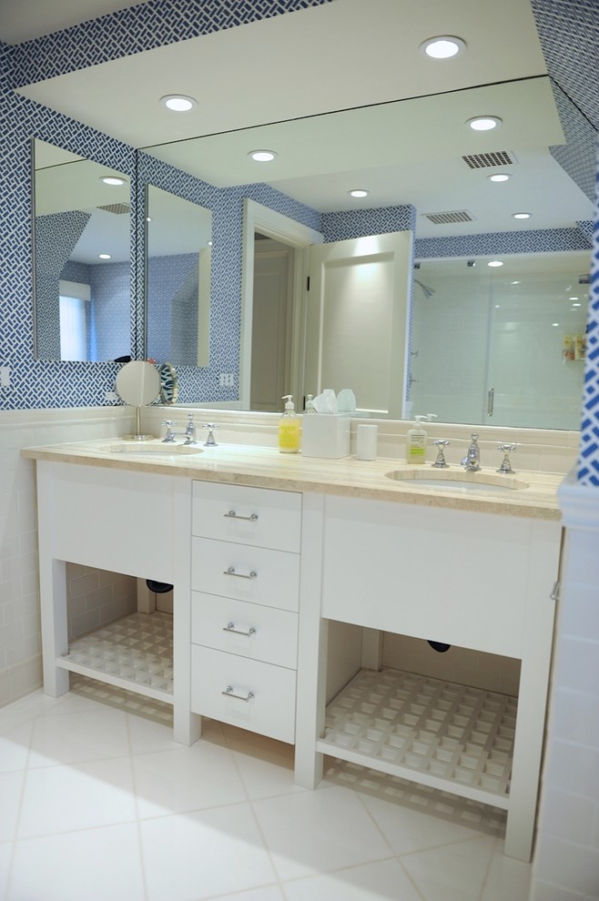 Small beach style master bathroom in New York with furniture-like cabinets, distressed cabinets, a two-piece toilet, blue walls, light hardwood floors, an integrated sink, marble benchtops, beige floor, white tile, subway tile and a hinged shower door.