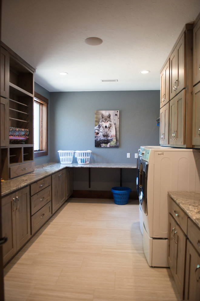 Inspiration for a huge rustic u-shaped gray floor utility room remodel with an undermount sink, flat-panel cabinets, light wood cabinets, granite countertops, blue walls, a side-by-side washer/dryer and multicolored countertops