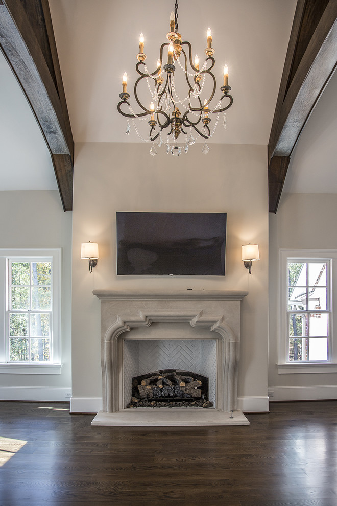 This is an example of a large contemporary master bedroom in Atlanta with white walls, dark hardwood floors, a standard fireplace and a concrete fireplace surround.