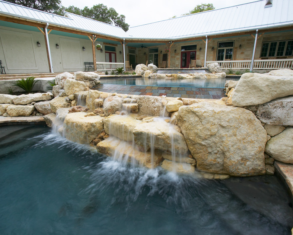 Example of a large mountain style courtyard concrete and custom-shaped natural pool fountain design in Austin