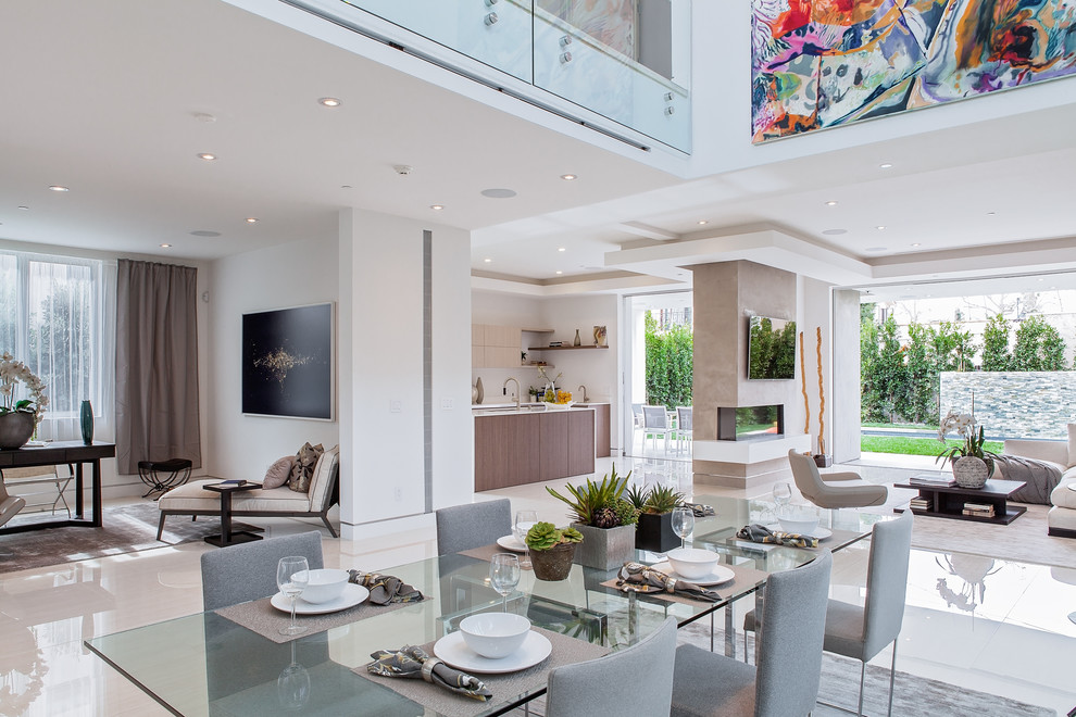 This is an example of an expansive contemporary open plan dining in Los Angeles with white walls.