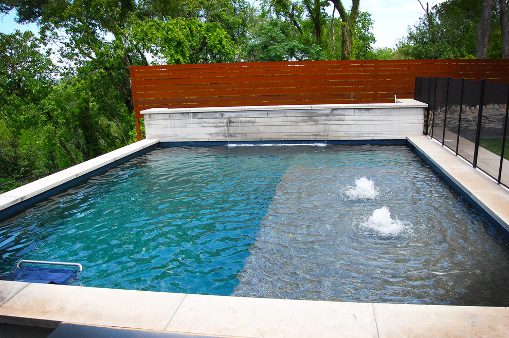 This is an example of a midcentury pool in Austin.