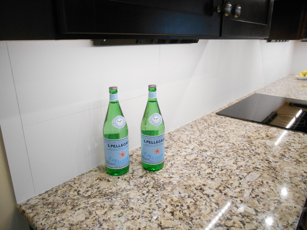 Transitional u-shaped eat-in kitchen photo in Birmingham with an undermount sink, shaker cabinets, dark wood cabinets, granite countertops, white backsplash, ceramic backsplash and stainless steel appliances