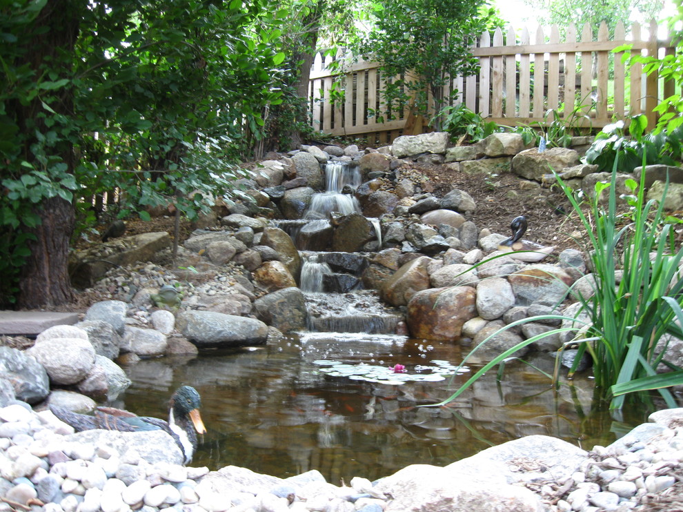 Inspiration for a large country garden in Omaha with a water feature.