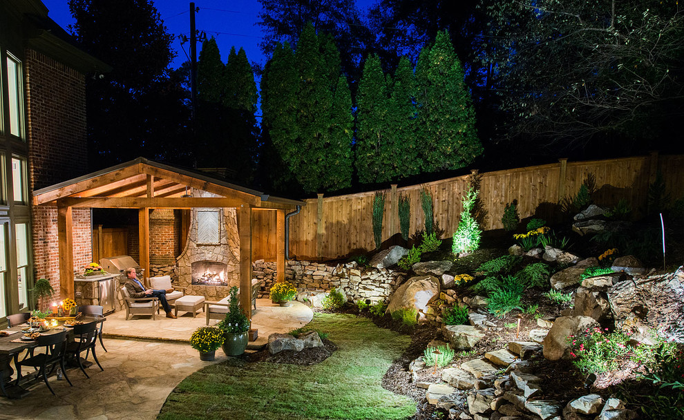 Large arts and crafts backyard partial sun garden in Atlanta with a fire feature and natural stone pavers.