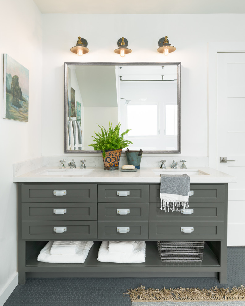 This is an example of a mid-sized traditional bathroom in Sacramento with shaker cabinets, grey cabinets, stone slab, white walls, ceramic floors, an undermount sink, grey floor and white tile.