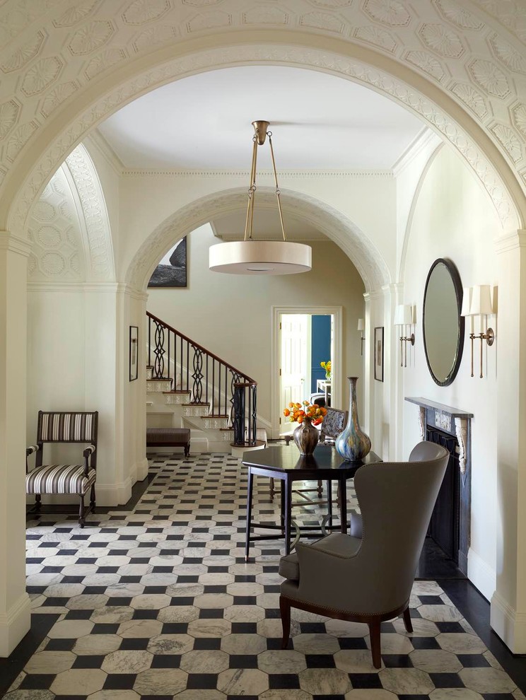 Photo of a traditional foyer in Other with beige walls and multi-coloured floor.