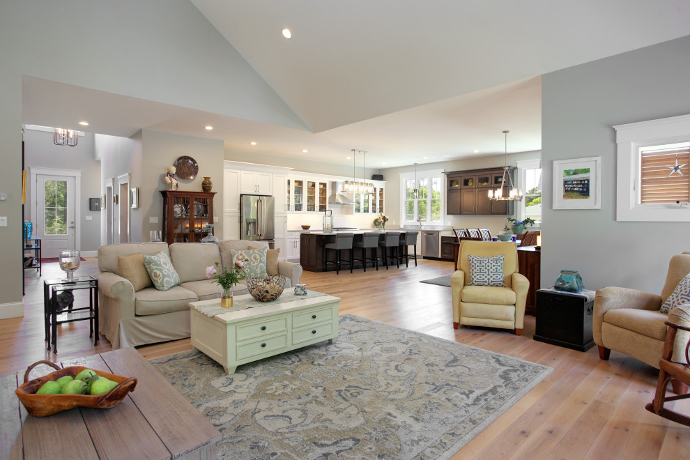Photo of an expansive rural open plan living room in Other with white walls, light hardwood flooring, a standard fireplace, a stone fireplace surround, a wall mounted tv and a vaulted ceiling.