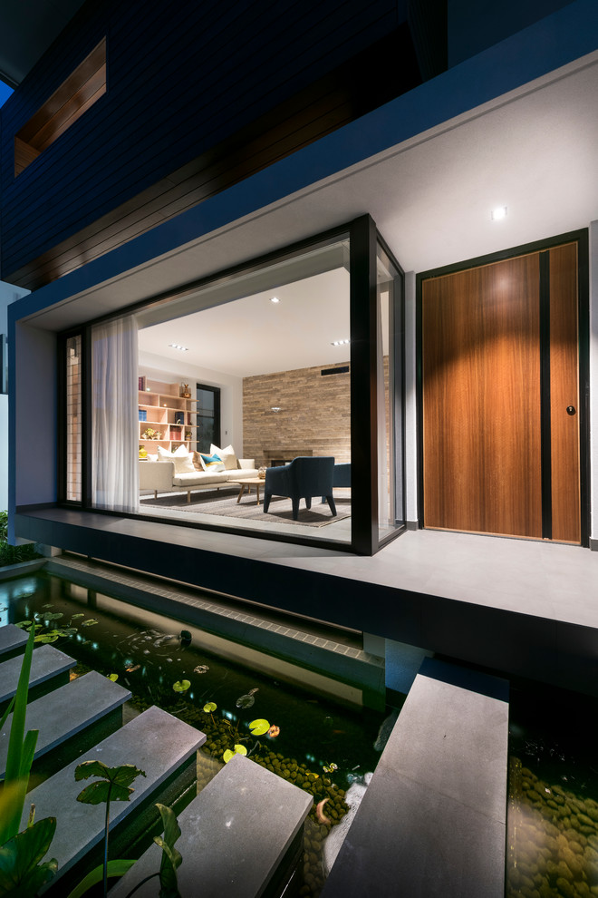 Inspiration for a contemporary living room in Perth with a library, a two-sided fireplace and a metal fireplace surround.