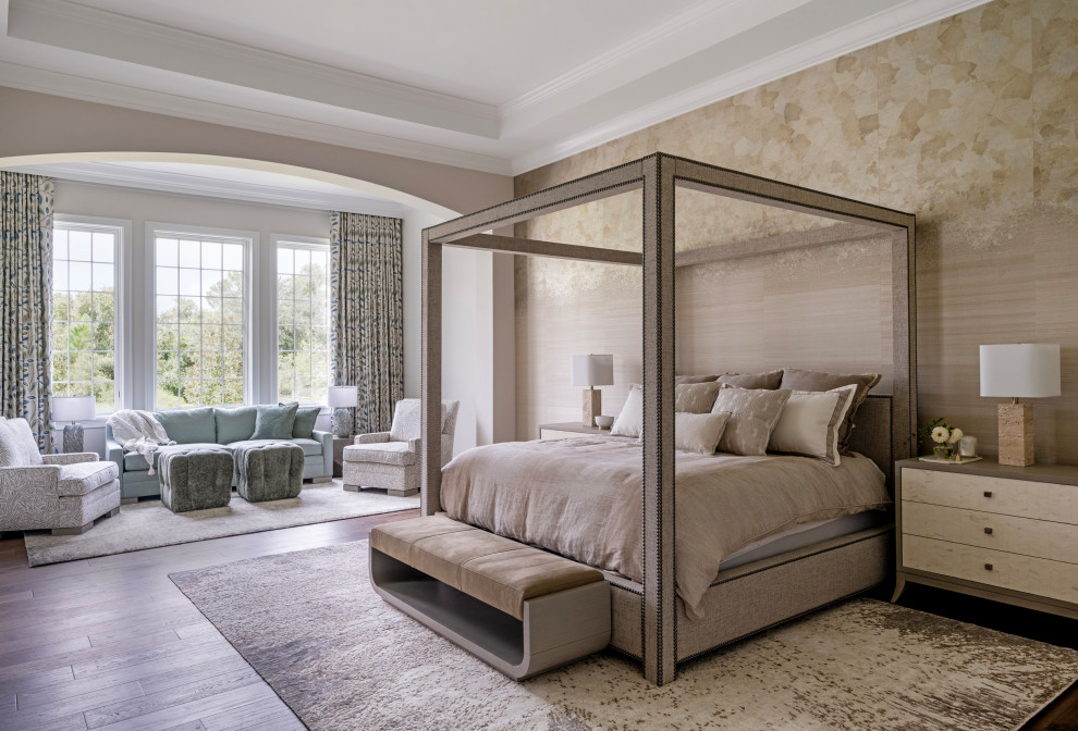 Example of a huge transitional master medium tone wood floor, brown floor, wallpaper and tray ceiling bedroom design in Tampa with beige walls