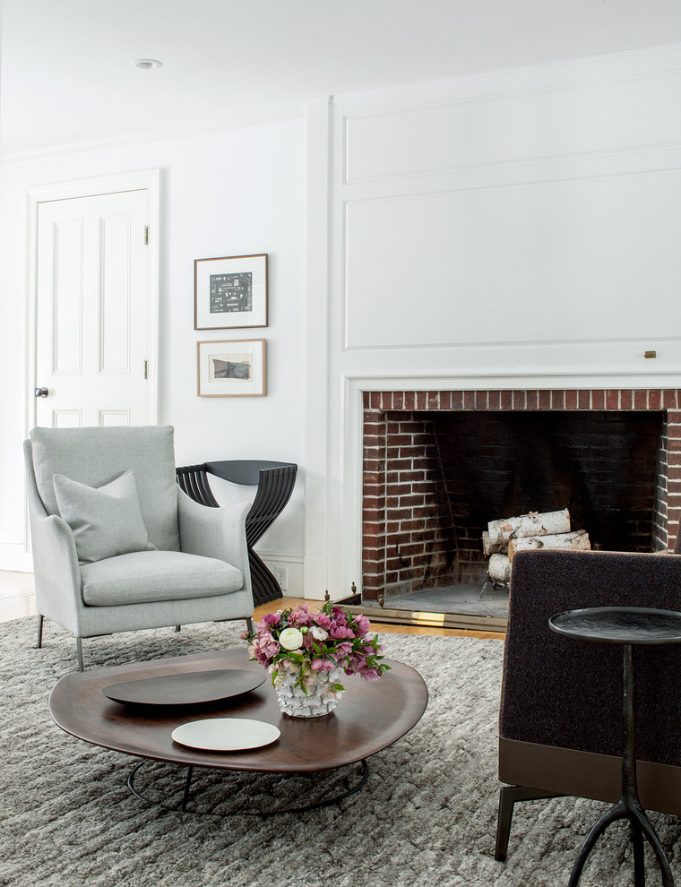 Transitional living room in Boston with white walls, medium hardwood floors and a standard fireplace.