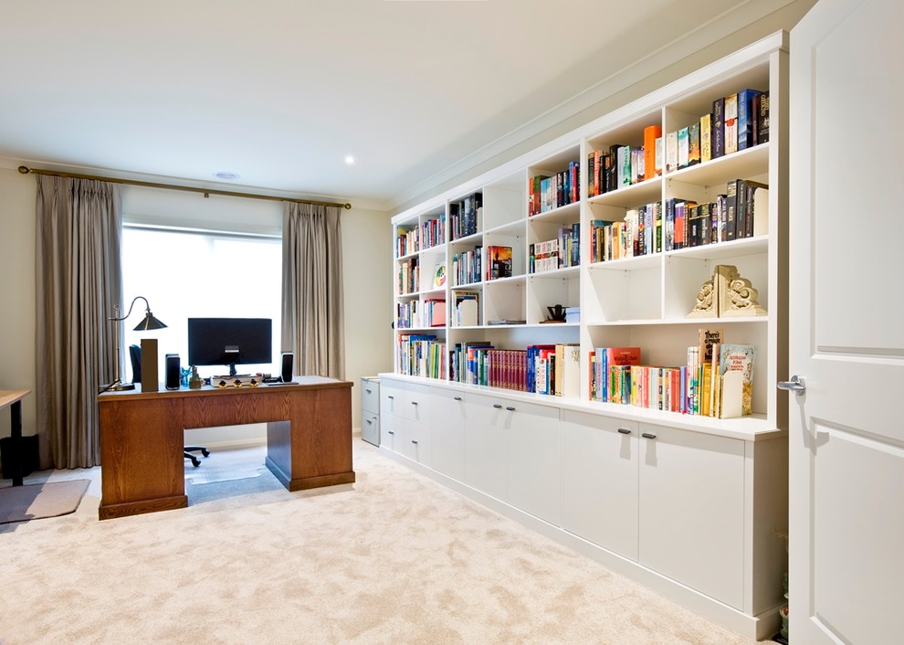 Mid-sized contemporary study room in Melbourne with beige walls, carpet, no fireplace and a freestanding desk.