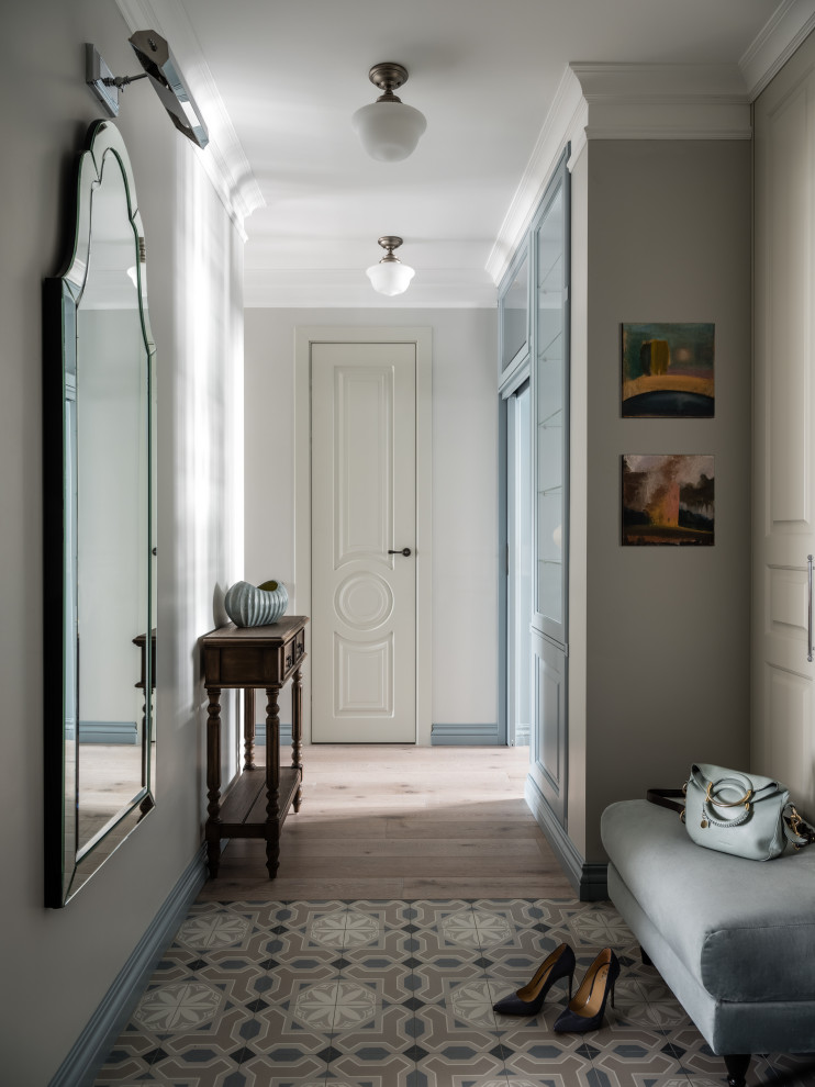 This is an example of a medium sized classic vestibule in Moscow with grey walls, porcelain flooring, multi-coloured floors, all types of ceiling, all types of wall treatment and feature lighting.