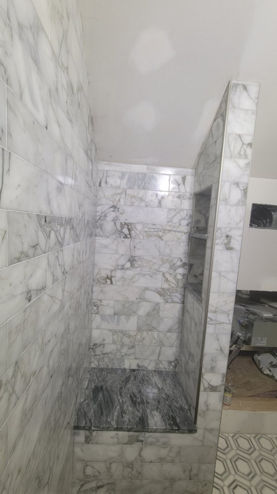 Photo of a small modern 3/4 bathroom in Columbus with an alcove shower, black and white tile, marble, marble floors, yellow floor, a shower seat, a single vanity and a freestanding vanity.