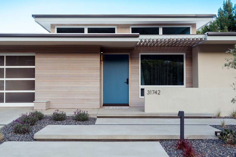 Inspiration for a small midcentury one-storey beige exterior in Orange County with mixed siding.
