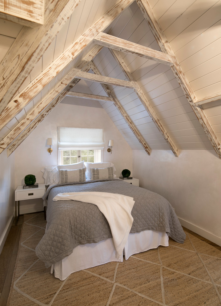 Design ideas for a small country loft-style bedroom in Santa Barbara with white walls and light hardwood floors.