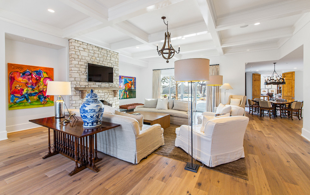 Large contemporary open concept family room in Dallas with white walls, medium hardwood floors, a standard fireplace, a stone fireplace surround, a wall-mounted tv and beige floor.