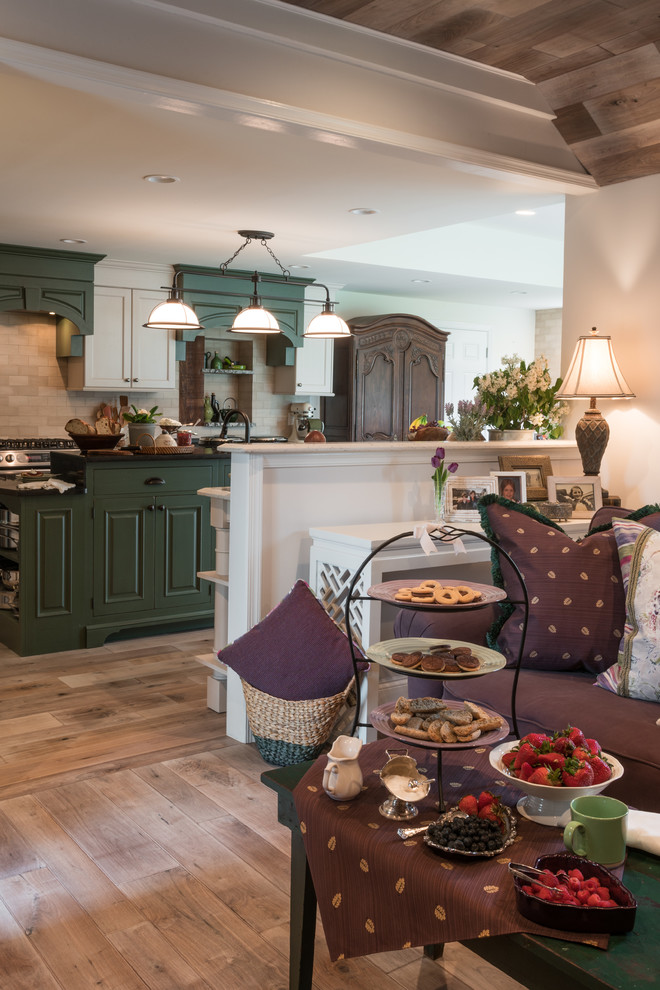 Inspiration for a large country galley eat-in kitchen in Philadelphia with a farmhouse sink, raised-panel cabinets, green cabinets, quartz benchtops, beige splashback, stone tile splashback, coloured appliances, light hardwood floors, with island and beige floor.