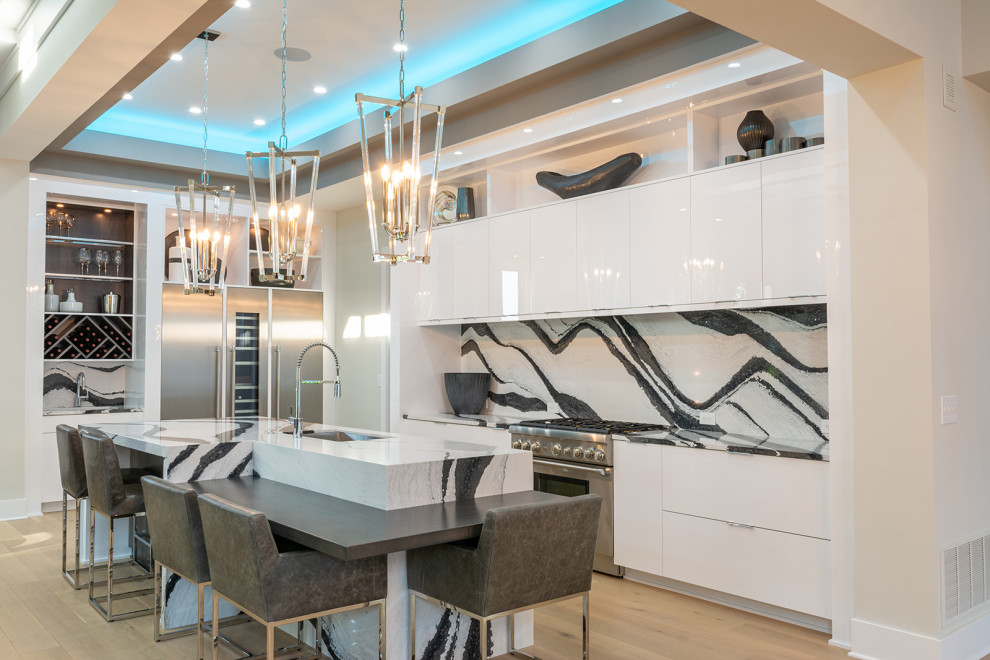 Inspiration for a contemporary eat-in kitchen in Columbus with an undermount sink, flat-panel cabinets, white cabinets, multi-coloured splashback, stainless steel appliances, medium hardwood floors, with island, brown floor and multi-coloured benchtop.