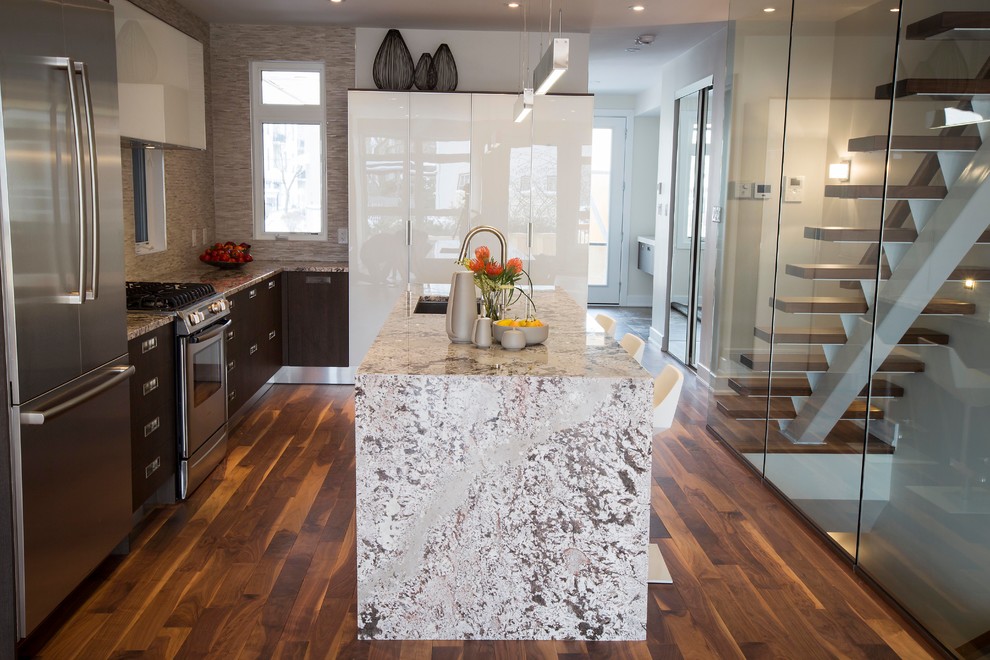 This is an example of a mid-sized contemporary l-shaped eat-in kitchen in Ottawa with an undermount sink, glass-front cabinets, brown cabinets, granite benchtops, brown splashback, mosaic tile splashback, stainless steel appliances, dark hardwood floors and with island.