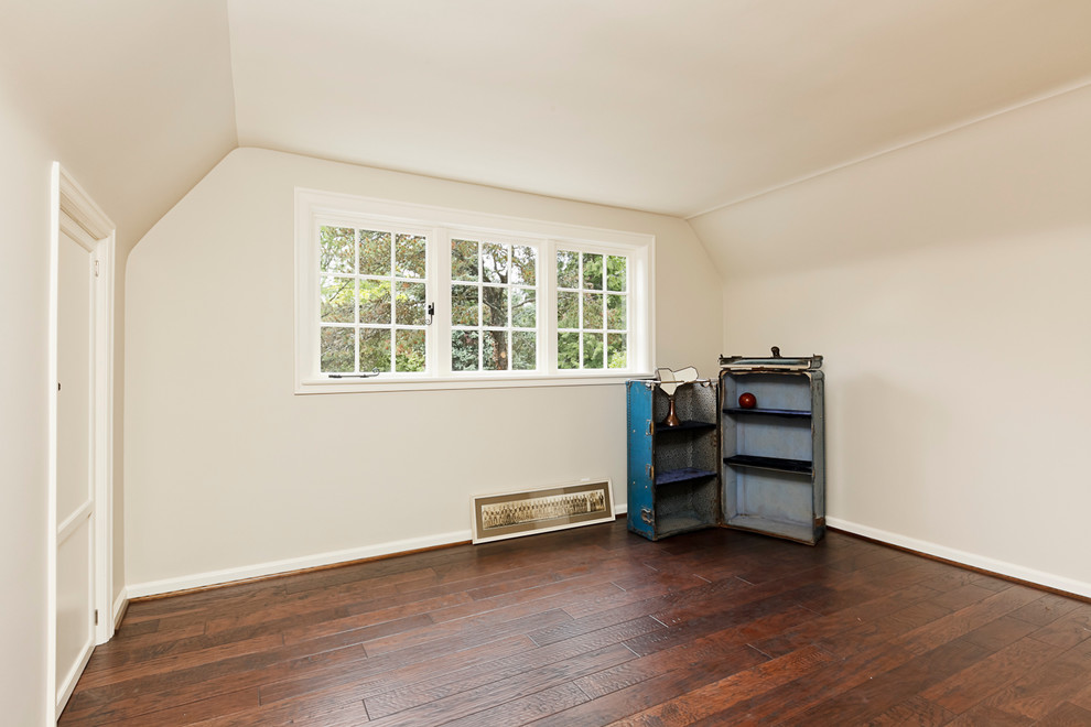 Large traditional guest bedroom in Portland with dark hardwood floors, no fireplace and beige walls.