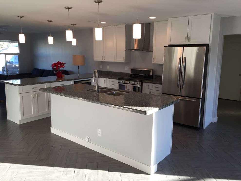 Mid-sized transitional u-shaped dark wood floor eat-in kitchen photo with a double-bowl sink, raised-panel cabinets, dark wood cabinets, wood countertops, white backsplash, subway tile backsplash, white appliances and no island