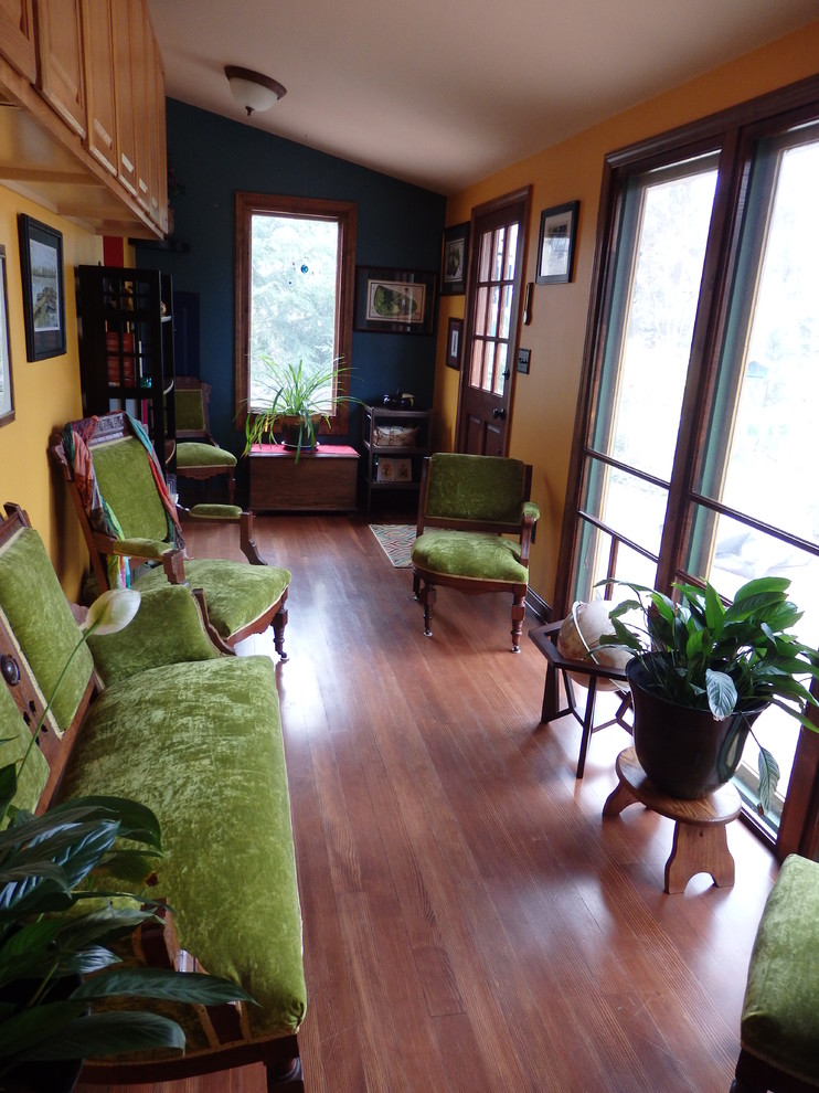 Small eclectic sunroom in Other with light hardwood floors, a standard ceiling, no fireplace and grey floor.