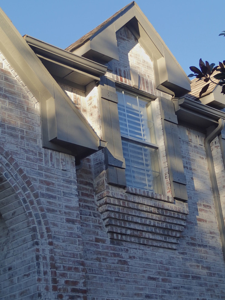 Inspiration for a large traditional two-storey brick white exterior in Dallas with a gable roof.