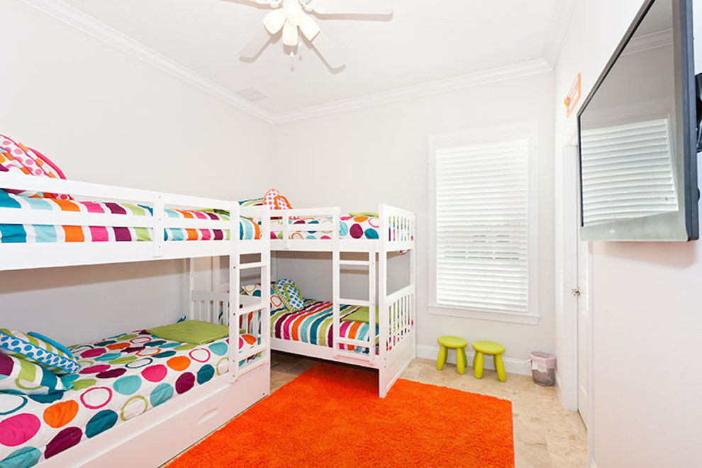 Photo of a mid-sized beach style gender-neutral kids' bedroom for kids 4-10 years old in Orlando with white walls and travertine floors.