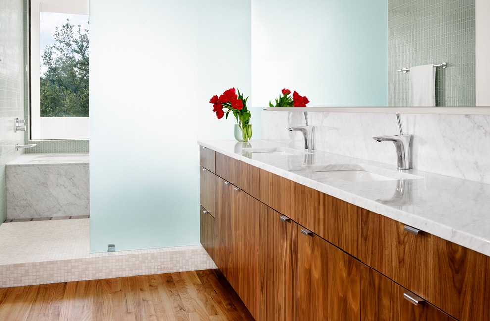 This is an example of a modern bathroom in Austin with an undermount sink, flat-panel cabinets, medium wood cabinets, an alcove tub, an open shower, beige tile, mosaic tile and an open shower.