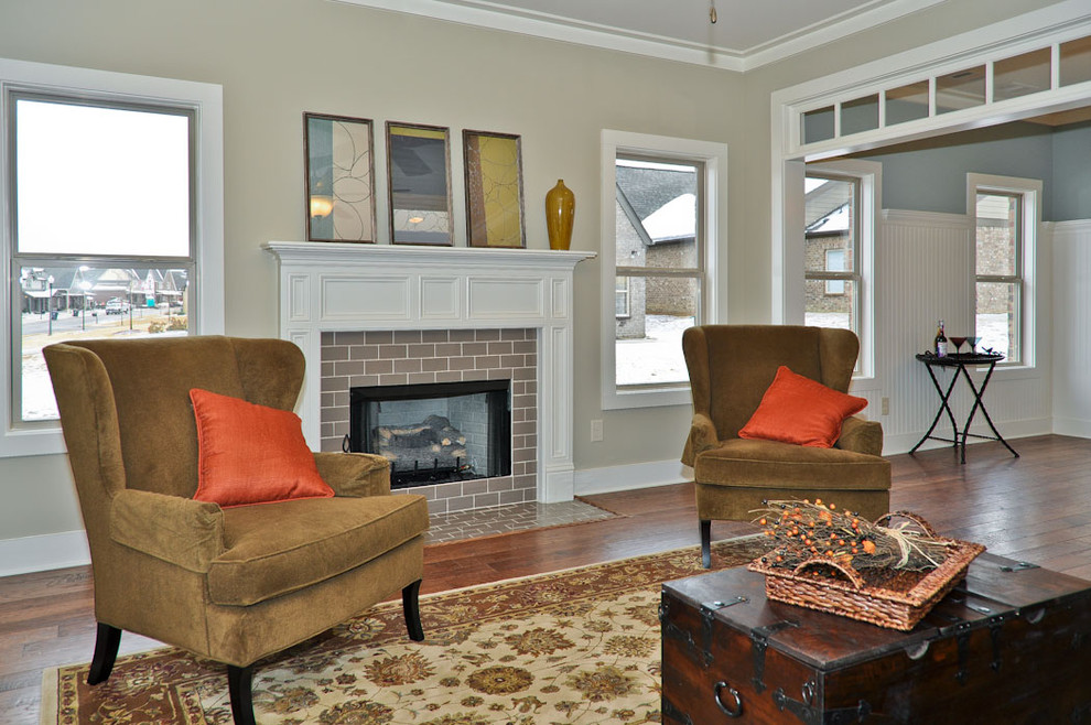 This is an example of a traditional living room in Birmingham with a tile fireplace surround.
