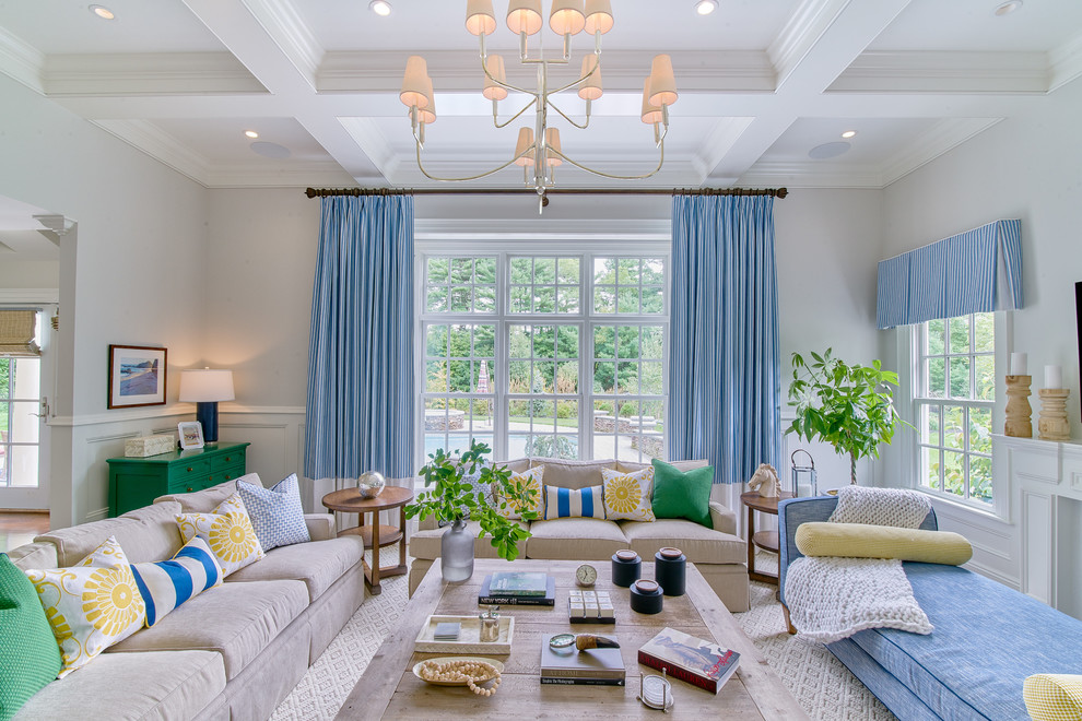 Large transitional open concept dark wood floor and brown floor living room photo in Boston with a standard fireplace, a wood fireplace surround, a wall-mounted tv and gray walls