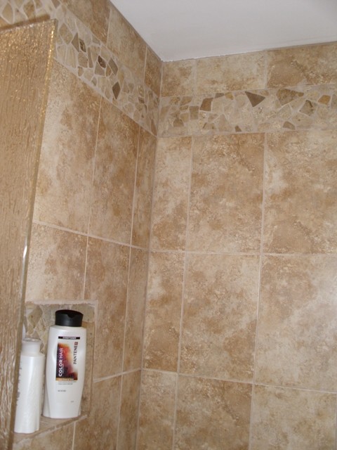 Corner bathtub - mid-sized traditional master brown tile and porcelain tile porcelain tile corner bathtub idea in Cincinnati with flat-panel cabinets, medium tone wood cabinets, a two-piece toilet, beige walls, an undermount sink and quartz countertops