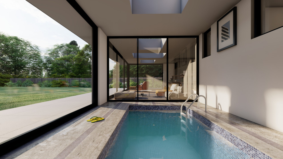 Design ideas for a mid-sized contemporary indoor rectangular natural pool in London with a pool house and tile.