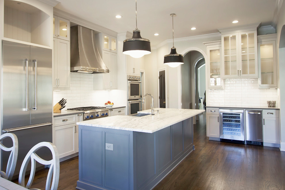 Example of a mid-sized transitional single-wall dark wood floor eat-in kitchen design in Charlotte with beaded inset cabinets, white cabinets, marble countertops, white backsplash, porcelain backsplash, stainless steel appliances, an island and a farmhouse sink
