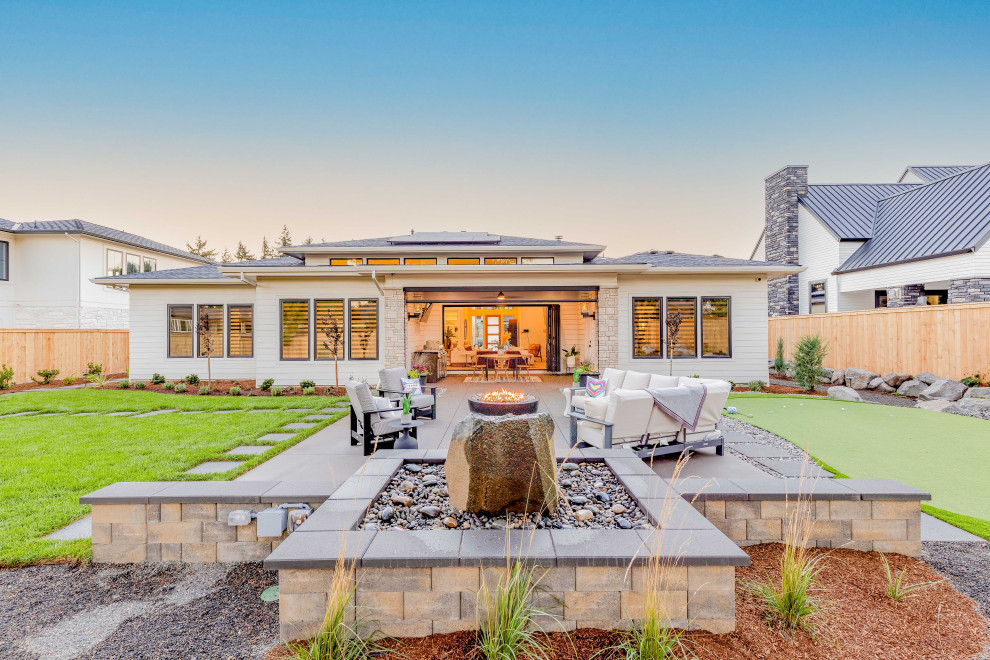 Inspiration for a mid-sized southwestern drought-tolerant and full sun backyard concrete paver and wood fence landscaping in Portland with a fire pit for summer.