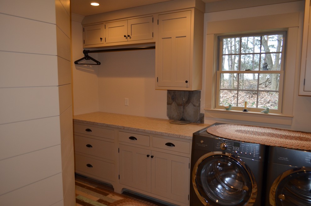 Mid-sized country single-wall dedicated laundry room in Other with shaker cabinets, beige cabinets, granite benchtops, a side-by-side washer and dryer, a drop-in sink, white walls, painted wood floors and multi-coloured floor.