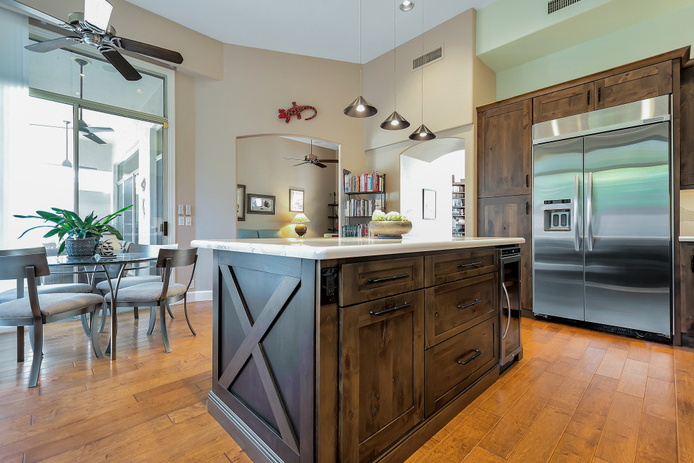 Inspiration for a large transitional u-shaped open concept kitchen remodel in Phoenix with a farmhouse sink, shaker cabinets, dark wood cabinets, quartz countertops, white backsplash, quartz backsplash, stainless steel appliances, an island and white countertops