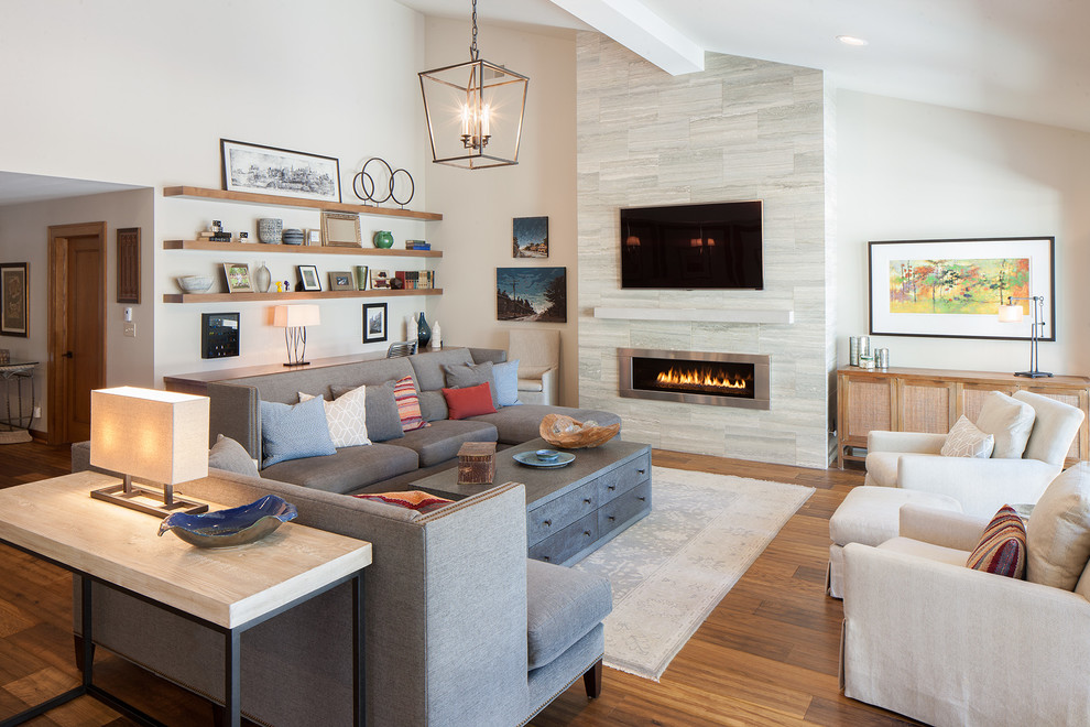 Inspiration for a large contemporary formal open concept living room in Grand Rapids with medium hardwood floors, a ribbon fireplace, a metal fireplace surround, a wall-mounted tv and beige walls.