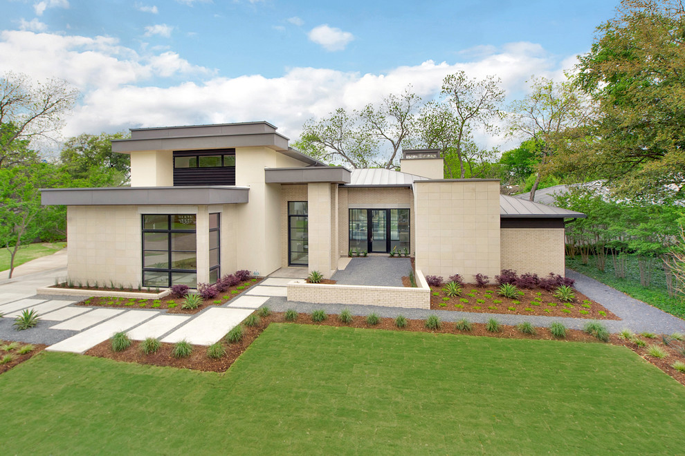 Photo of a modern two-storey beige exterior in Dallas with mixed siding and a flat roof.