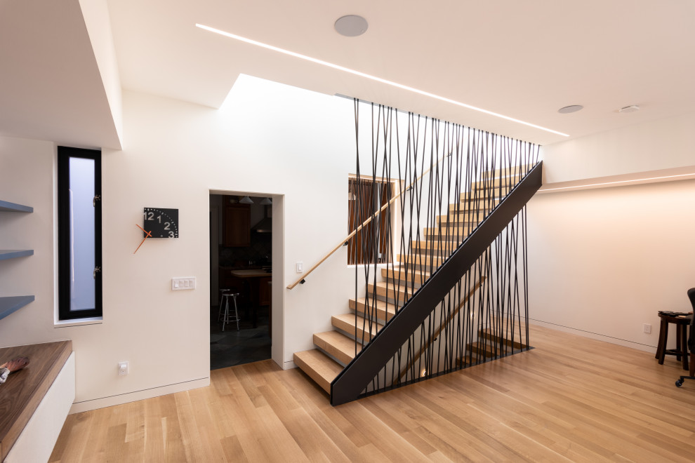 Inspiration for a mid-sized modern wooden straight open and metal railing staircase remodel in San Francisco