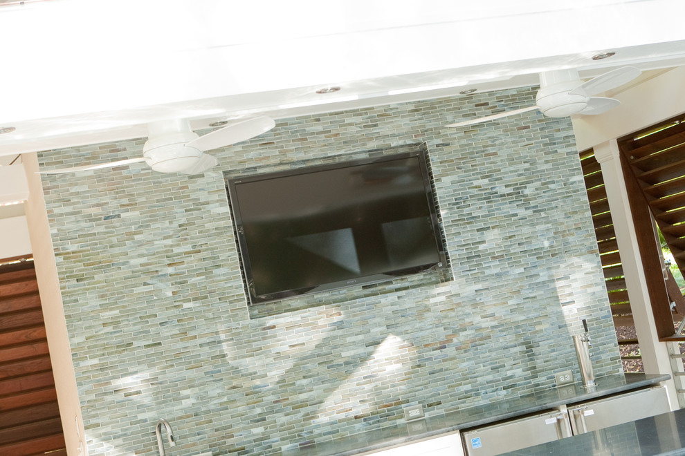 Example of a large trendy backyard custom-shaped and tile natural pool house design