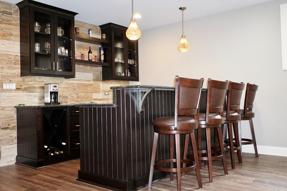 Design ideas for a mid-sized transitional galley seated home bar in Chicago with vinyl floors, open cabinets, black cabinets, beige splashback and brown floor.