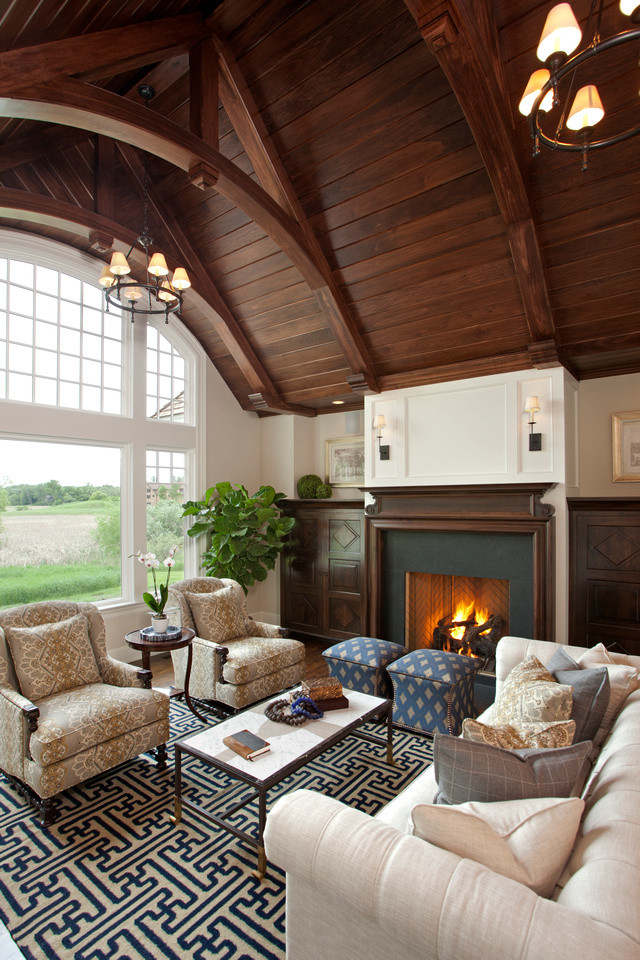 Photo of a mid-sized traditional formal living room in Minneapolis with beige walls, dark hardwood floors, a standard fireplace, a stone fireplace surround and no tv.