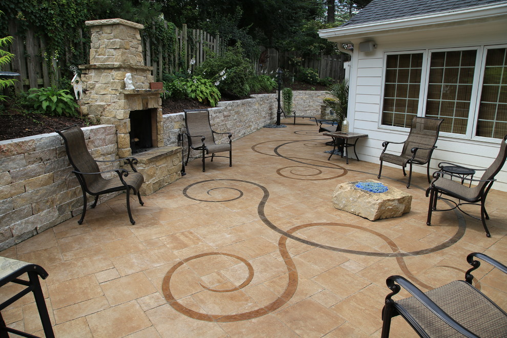 Inspiration for a mid-sized eclectic backyard patio in Omaha with concrete pavers.