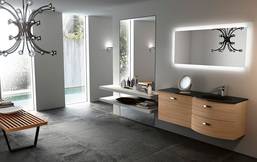 Inspiration for a small modern 3/4 bathroom in San Diego with an integrated sink, flat-panel cabinets, medium wood cabinets, glass benchtops, a freestanding tub, a corner shower, gray tile, ceramic tile, grey walls and ceramic floors.