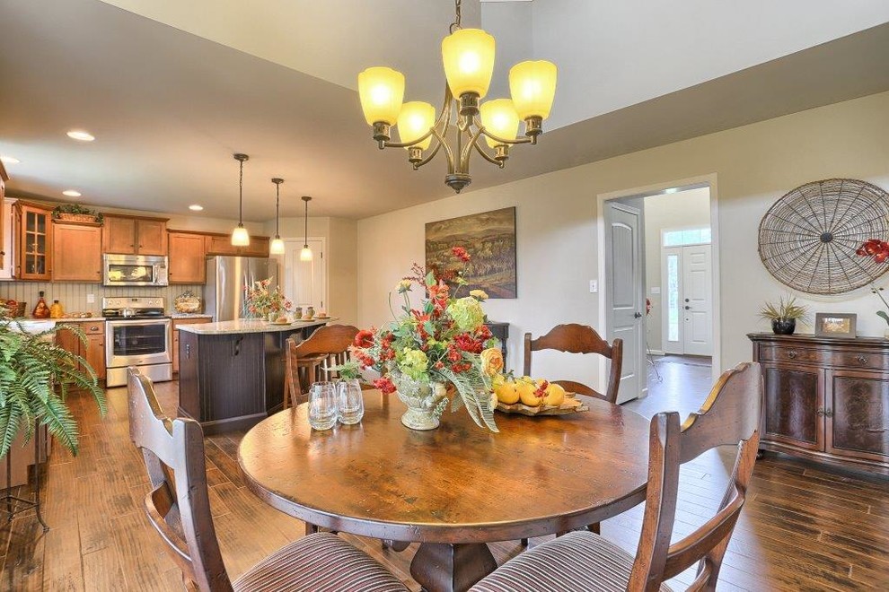 This is an example of a mid-sized country open plan dining in Philadelphia with medium hardwood floors.