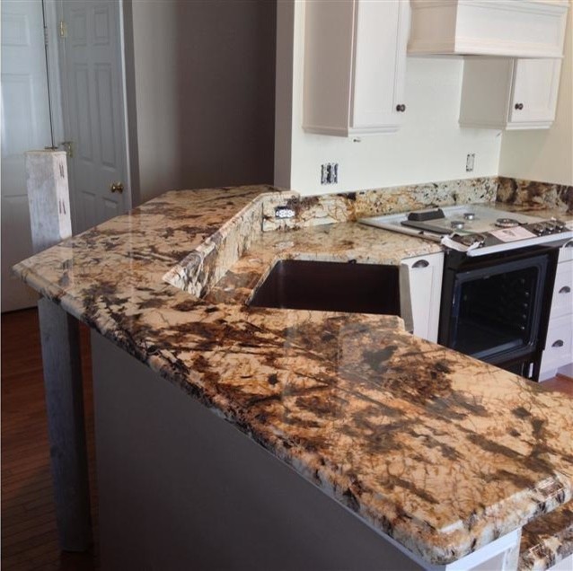 Kitchen photo in DC Metro with a farmhouse sink, recessed-panel cabinets, white cabinets, granite countertops and a peninsula