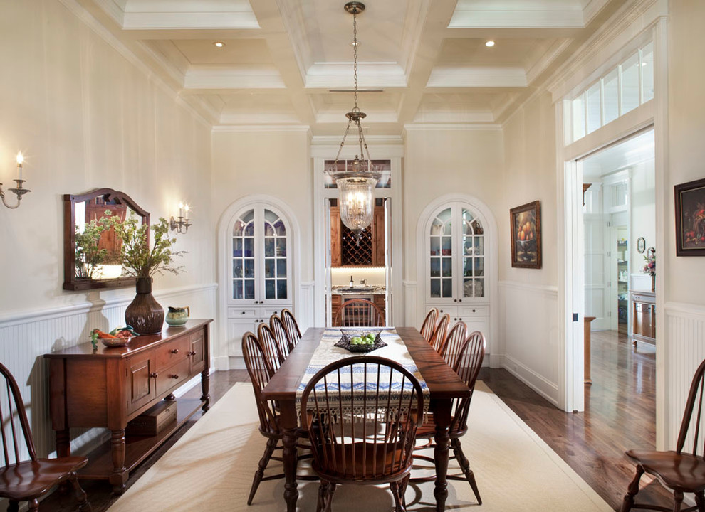 Photo of a traditional separate dining room in Tampa with beige walls and dark hardwood floors.