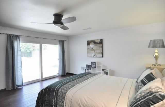 Inspiration for a large contemporary master bedroom in Dallas with white walls, bamboo floors and no fireplace.